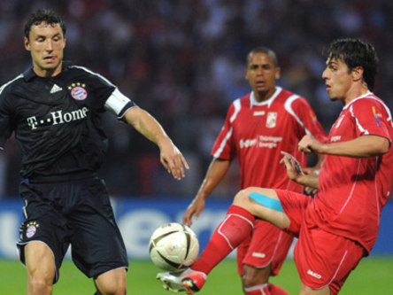 Münchens Van Bommel im Duell mit Erfurts Cannizzaro (re.). Rochenbach schaut zu.