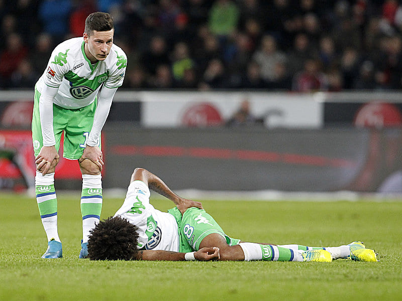 Schmerz lass nach: Wolfsburgs Julian Draxler schaut nach dem am Boden liegenden Dante.