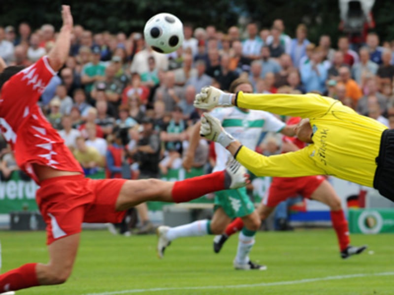Nordhorns Stürmer Brode und Werders Keeper Wiese strecken sich nach dem Ball.