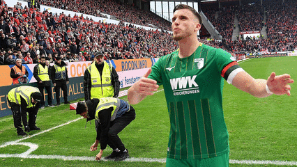 Beruhigende Wirkung? Kapitän Ermedin Demirovic spricht auf die FCA-Fans ein.