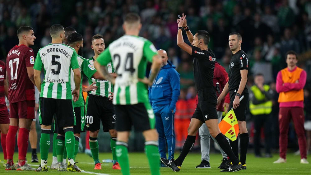 Diese Szene gab es im Sevilla-Derby dreimal: Schiedsrichter José Maria Sanchez Martinez korrigiert sich nach Ansicht der Bilder und macht aus einer Gelben eine Rote Karte.