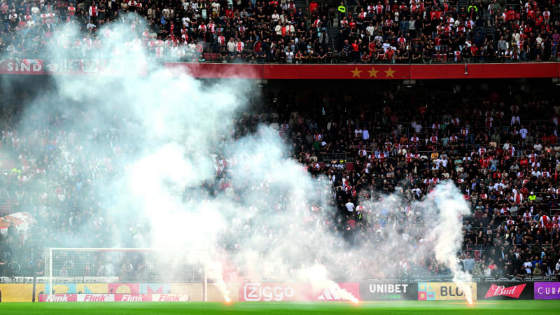 This photograph taken on September 24, 2023, shows smoke rising from fireworks thrown on the field by Ajax' supporters during the Dutch Eredivisie football match between Ajax Amsterdam and Feyenoord at the Johan Cruijff Arena in Amsterdam. (Photo by Olaf Kraak / ANP / AFP) / Netherlands OUT (Photo by OLAF KRAAK/ANP/AFP via Getty Images)