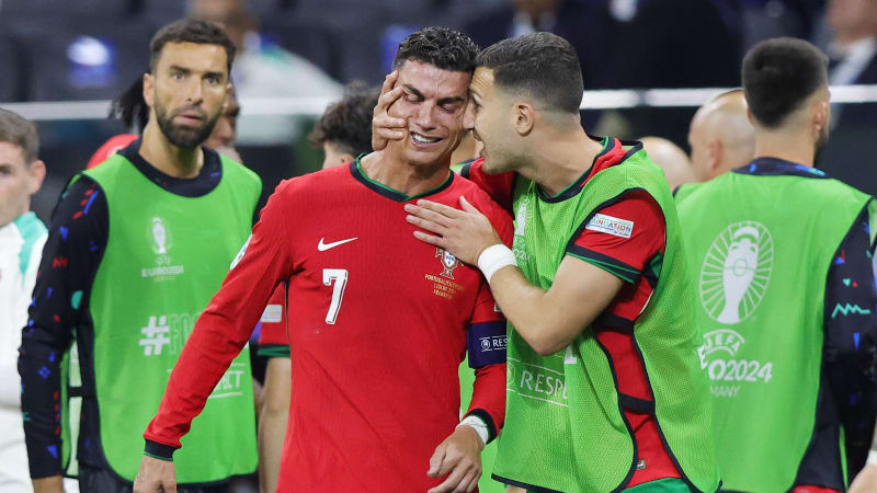 FRANKFURT AM MAIN, GERMANY - JULY 1: Cristiano Ronaldo of Portugal (L) is crying after the missed penalty kick during the UEFA EURO 2024 round of 16 match between Portugal and Slovenia at Frankfurt Arena on July 1, 2024 in Frankfurt am Main, Germany. (Photo by Ralf Ibing - firo sportphoto/Getty Images)