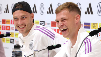 HERZOGENAURACH, GERMANY - JULY 01: David Raum of Germany smiles with Joshua Kimmich (R) during a press conference at adidas HQ Herzo-Base on July 01, 2024 in Herzogenaurach, Germany. (Photo by Alexander Hassenstein/Getty Images)