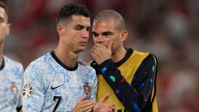 GELSENKIRCHEN, GERMANY - JUNE 26:  Cristiano Ronaldo and Pepe of Portugal whisper to each other after the UEFA EURO 2024 group stage match between Georgia and Portugal at Arena AufSchalke on June 26, 2024 in Gelsenkirchen, Germany. (Photo by Visionhaus/Getty Images)