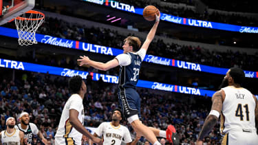 Nov 21, 2025; Dallas, Texas, USA; Dallas Mavericks forward Cooper Flagg (32) dunks the ball over New Orleans Pelicans center Derik Queen (22) and forward Herbert Jones (2) during the second half at the American Airlines Center. Mandatory Credit: Jerome Miron-Imagn Images