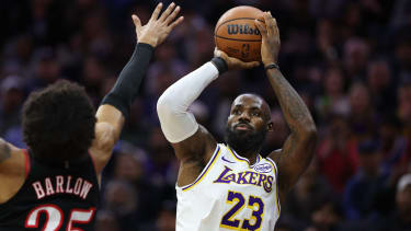 Dec 7, 2025; Philadelphia, Pennsylvania, USA; Los Angeles Lakers forward Lebron James (23) shoots past Philadelphia 76ers forward Dominick Barlow (25) during the first quarter at Xfinity Mobile Arena. Mandatory Credit: Bill Streicher-Imagn Images