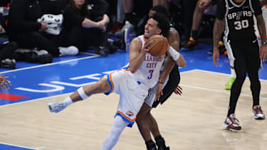 May 26, 2026; Oklahoma City, Oklahoma, USA; Oklahoma City Thunder guard Jared McCain (3) is fouled by San Antonio Spurs guard De'aaron Fox (4) during the third quarter in game five of the western conference finals for the 2026 NBA playoffs at Paycom Center. Mandatory Credit: Brett Rojo-Imagn Images
