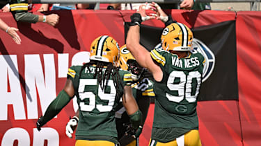 Oct 4, 2026; Tampa, Florida, USA;  Green Bay Packers linebacker Ty'ron Hopper (59) and defensive end Brenton Cox Jr. (57) and defensive end Lukas Van Ness (90) celebrate during the game against the Tampa Bay Buccaneers at Raymond James Stadium.  Mandatory Credit: Jonathan Dyer-Imagn Images