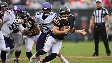 Sep 20, 2026; Chicago, Illinois, USA;  Chicago Bears quarterback Caleb Williams (18) scrambles against Minnesota Vikings linebacker Dallas Turner (15) and defensive tackle Levi Drake Rodriguez (50) during the first quarter at Soldier Field.  Mandatory Credit: Patrick Gorski-Imagn Images