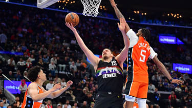 Nov 12, 2025; Inglewood, California, USA; Denver Nuggets center Nikola Jokic (15) moves to the basket against Los Angeles Clippers forward Derrick Jones Jr. (5) during the second half at Intuit Dome. Mandatory Credit: Gary A. Vasquez-Imagn Images