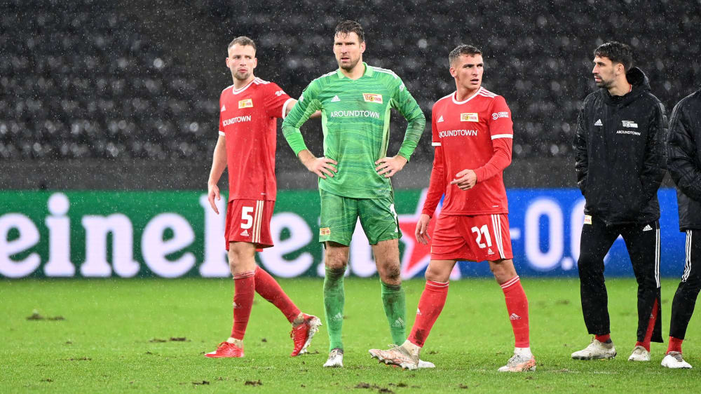 Cheer up: Unions Marvin Friedrich (left) and Rani Khedira (right) defended keeper Andreas Luthe (in green).