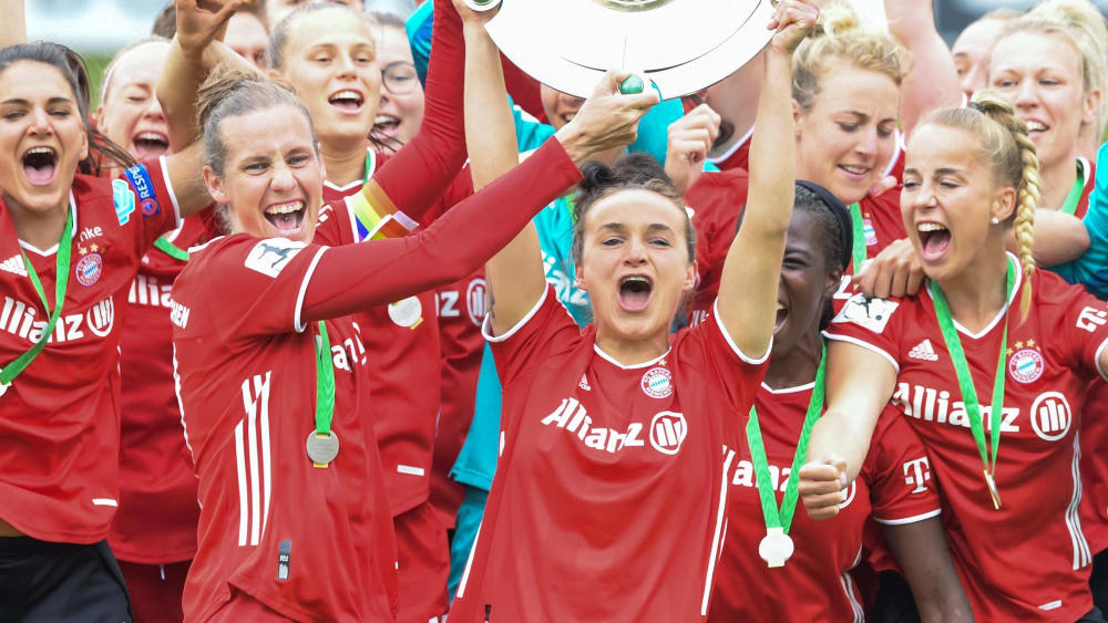 Lina Magull (re.) präsentiert gemeinsam mit Simone Laudehr die Meisterschale.