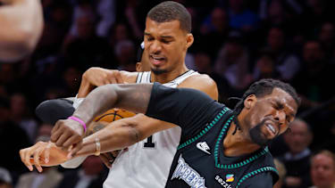 May 10, 2026; Minneapolis, Minnesota, USA; San Antonio Spurs center Victor Wembanyama (1) commits a level two flagrant foul against Minnesota Timberwolves center Naz Reid (11) in the second quarter of game four of the second round of the 2026 NBA Playoffs at Target Center. Wembanyama had to leave the game. Mandatory Credit: Bruce Kluckhohn-Imagn Images
