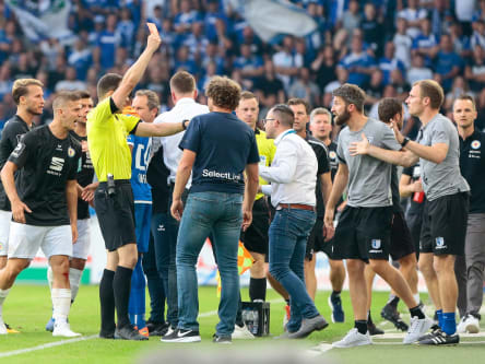 Felix Zwayer stellt Magdeburgs Co-Trainer Silvio Bankert (r.) vom Platz