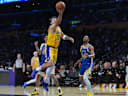 Oct 21, 2026; Los Angeles, California, USA; Los Angeles Lakers guard Luka Doncic (77) shoots the ball against the Golden State Warriors in the first half at Crypto.com Arena. Mandatory Credit: Kirby Lee-Imagn Images