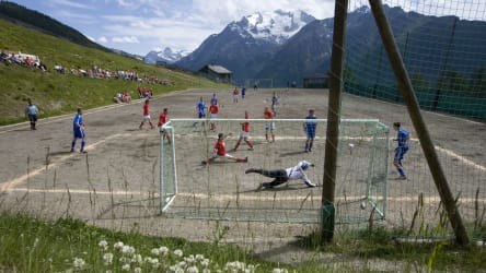 Fußballplatz umgeben von der Schweizer Bergwelt.