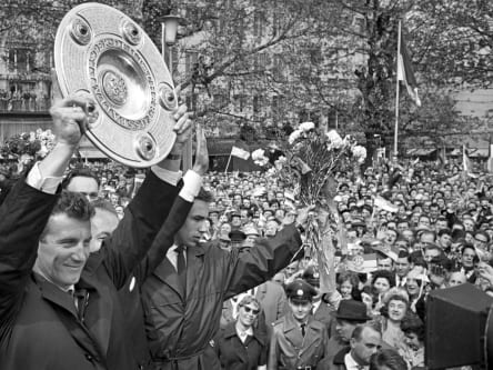 The 1. FC Köln team celebrates their championship title from the 1963/64 season on May 10, 1964 at the Neumarkt in Cologne.  Köln player Hans Schäfer (l) with the championship trophy.