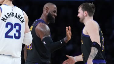 Nov 18, 2025; Los Angeles, California, USA; Los Angeles Lakers forward LeBron James (center) and guard Luka Doncic (77) react as Utah Jazz forward Lauri Markkanen (23) watches in the fourth quarter at Crypto.com Arena. Mandatory Credit: Kirby Lee-Imagn Images