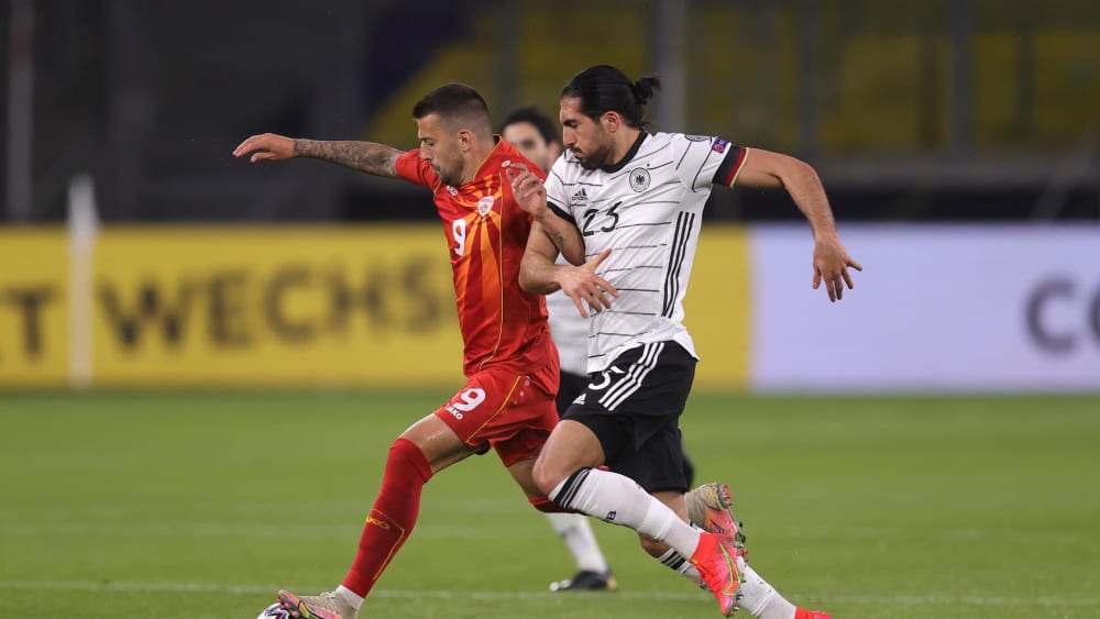 DUISBURG, GERMANY - MARCH 31: Aleksandar Trajkovski of North Macedonia and Emre Can of Germany battle for possession during the FIFA World Cup 2022 Qatar qualifying match between Germany and North Macedonia at Schauinsland-Reisen-Arena on March 31, 2021 in Duisburg, Germany. Sporting stadiums around Germany remain under strict restrictions due to the Coronavirus Pandemic as Government social distancing laws prohibit fans inside venues resulting in games being played behind closed doors. (Photo by Alex Grimm/Getty Images)