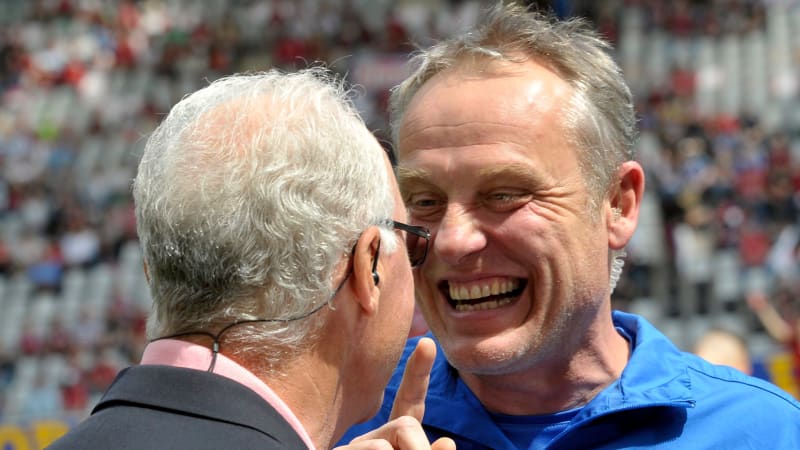 Freiburg's headcoach Christian Streich (R) talks with German football legend Franz Beckenbauer prior to the German first division Bundesliga football match SC Freiburg vs Schalke 04 in Freiburg, southwestern Germany, on May 18, 2013.     AFP PHOTO / THOMAS KIENZLE

RESTRICTIONS / EMBARGO - DFL RULES TO LIMIT THE ONLINE USAGE DURING MATCH TIME TO 15 PICTURES PER MATCH. IMAGE SEQUENCES TO SIMULATE VIDEO IS NOT ALLOWED AT ANY TIME.  FOR FURTHER QUERIES PLEASE  CONTACT THE  DFL DIRECTLY AT + 49 69 650050.        (Photo credit should read THOMAS KIENZLE/AFP via Getty Images)