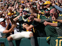 Green Bay Packers wide receiver Christian Watson (9) does a Lambeau Leap after scoring a touchdown against the Chicago Bears on Oct. 11, 2026, at Lambeau Field in Green Bay, Wis. The Packers defeated the Bears 31-7.