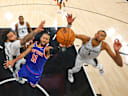 Jun 5, 2026; San Antonio, Texas, USA; New York Knicks guard Jalen Brunson (11) drives to the basket past San Antonio Spurs forward Julian Champagnie (30) and forward Victor Wembanyama (1) during game two of the 2026 NBA Finals at Frost Bank Center. Mandatory Credit: Gregory Shamus-Pool Photo via Imagn Images