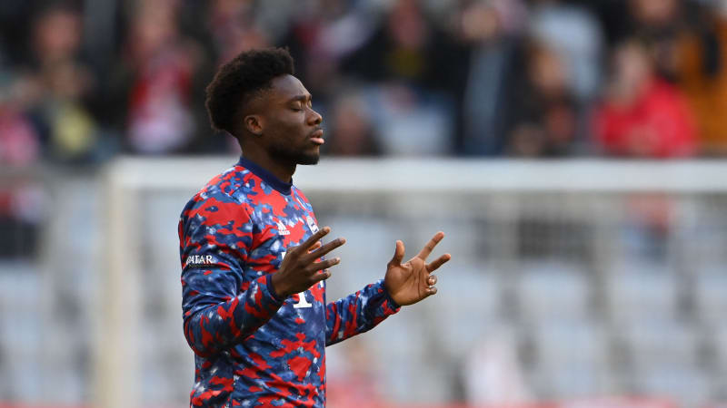 Bayern Munich's Canadian midfielder Alphonso Davies prays prior to the warm up of the German first division Bundesliga football match between FC Bayern Munich vs SC Freiburg in Munich, southern Germany, on November 6, 2021. (Photo by Christof STACHE / AFP) (Photo by CHRISTOF STACHE/AFP via Getty Images)