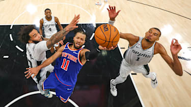 Jun 5, 2026; San Antonio, Texas, USA; New York Knicks guard Jalen Brunson (11) drives to the basket past San Antonio Spurs forward Julian Champagnie (30) and forward Victor Wembanyama (1) during game two of the 2026 NBA Finals at Frost Bank Center. Mandatory Credit: Gregory Shamus-Pool Photo via Imagn Images